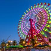 lit up ferris wheel at an amusement park at night