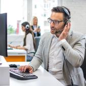 Customer service representative on the phone at a computer
