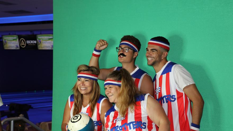 Bowlers in a group taking a picture at a selfie station