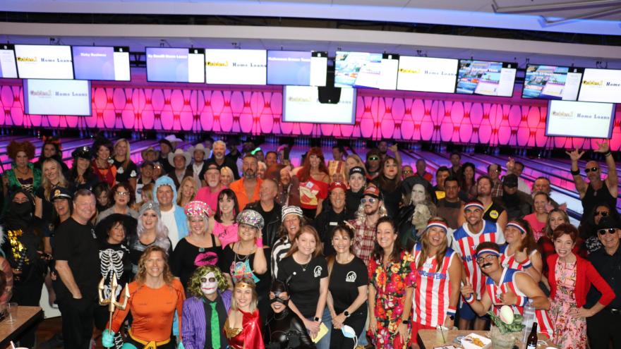 Group photo in front of bowling lanes