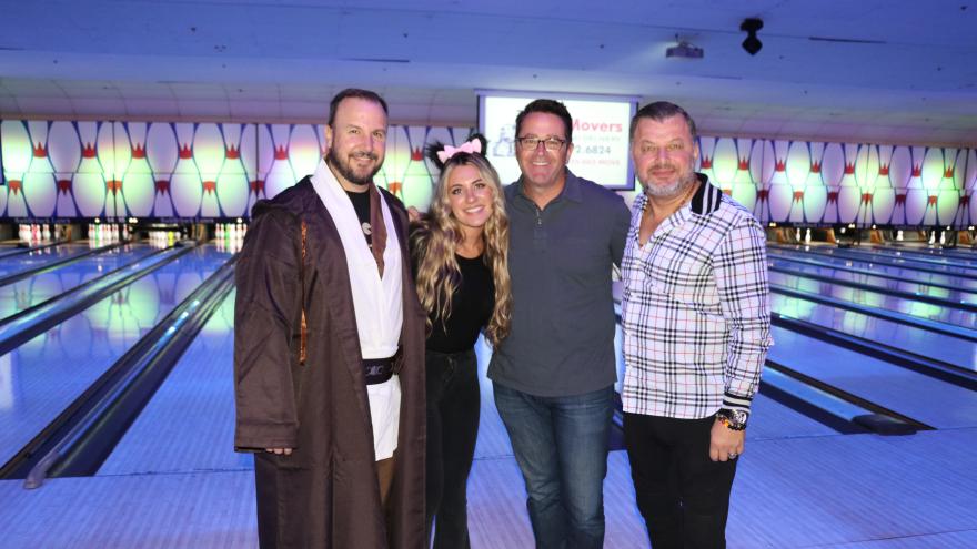 Group of bowlers in costume posing for a picture