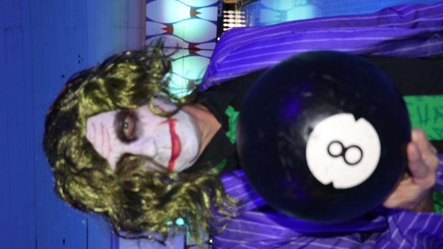 Guest in costume holding a bowling ball