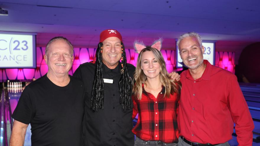 Group of bowlers in costume posing for a picture