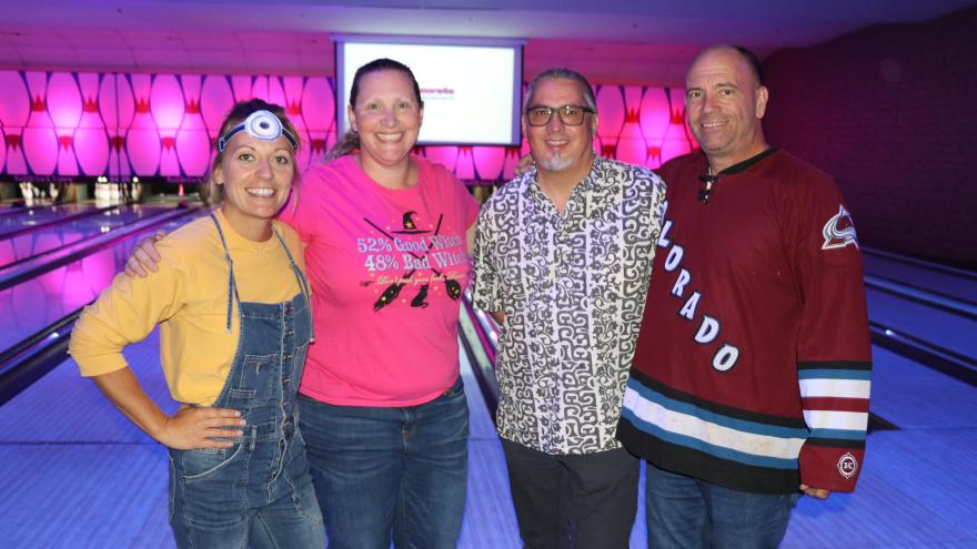 Group of bowlers in costumer posing for a picture