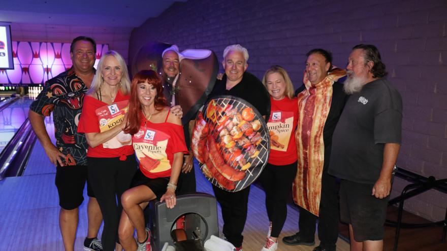 Group of bowlers in costumer posing for a picture