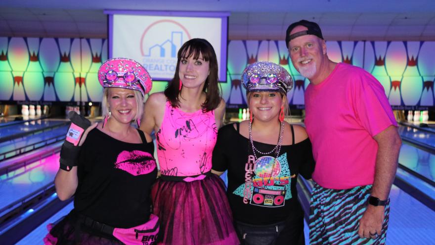 Group of bowlers in costumer posing for a picture