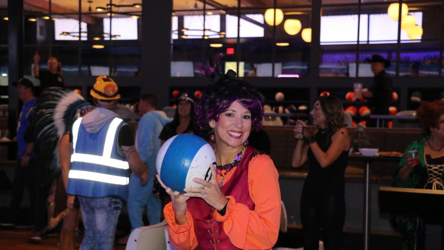 Lady in costume holding a bowling ball