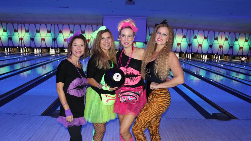 Group of bowlers in costumer posing for a picture