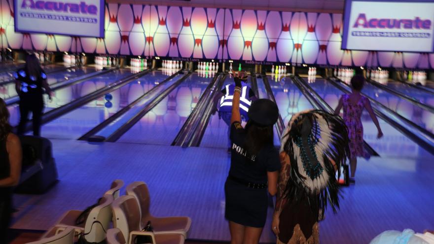 Guests in costumes in front of the lanes