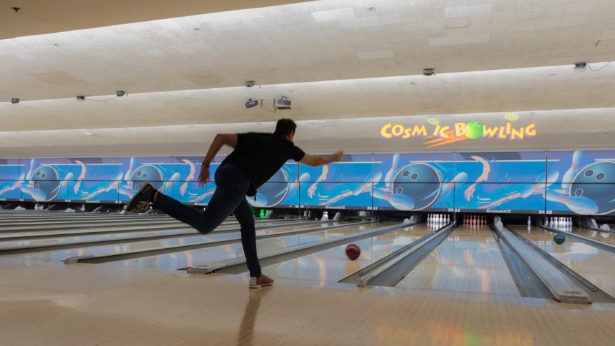 Bowler throwing a ball down a lane