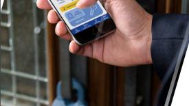 Supra Lockbox on Door with Agent Holding Phone with Supra App