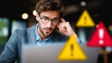 Man at computer with warning signs